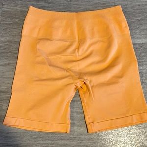Aurola intensify workout shorts. Color: Papaya